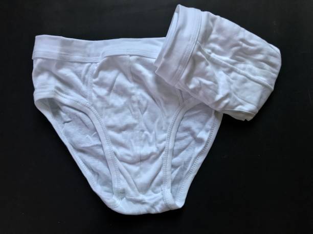 istock White color men underwear on black background 988213234
