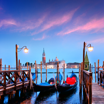 Gondolas at twilight in Venice, Italy. Composite photo