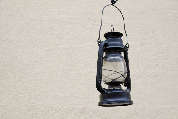 istock Old kerosene lamp on the background light walls. Space for text 988213730