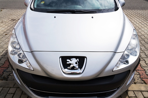 Prague, Czech Republic - March 29, 2018: Peugeot company logo on silver car on March 29, 2018 in Prague, Czech Republic.