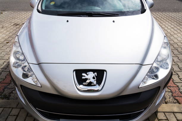 Peugeot company logo on silver car stock photo