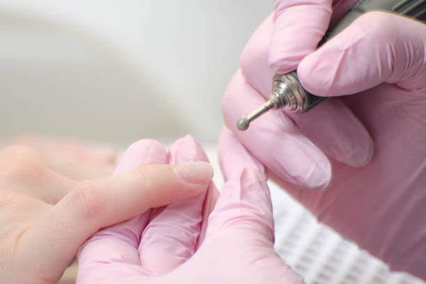 istock Nail treatment with a manicure cutter. Close up 988220604
