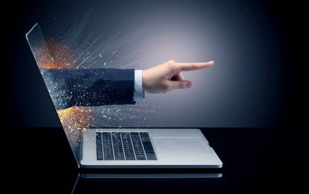 istock Hand coming out of a laptop 988225224