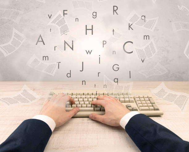 istock Elegant businessman hand typing with fluttering papers around 988228378