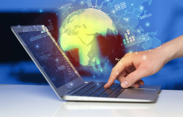 istock Hand using laptop with worldwide reports links and statistics concept 988229440
