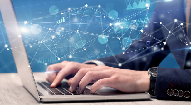 istock Hand typing on laptop with linked report and charts around 988229688