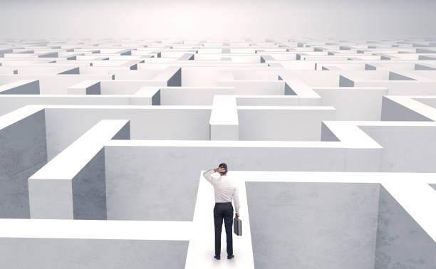 istock Small businessman in a middle of a maze 988230108