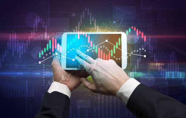 istock Hand holding tablet with global reports and stock market change concept 988233608