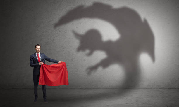 istock Businessman with imp shadow and toreador concept 988233994