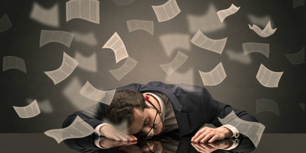 istock Businessman fell asleep at the office with paperwork concept 988234464