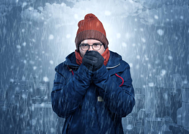 istock Boy freezing in cold weather with city concept 988235204