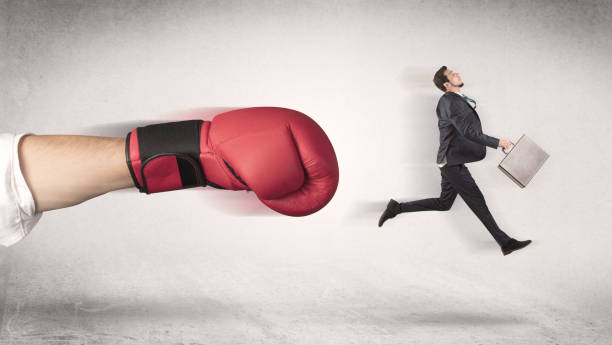 istock Businessman gets fired by a huge boxing hand 988235926