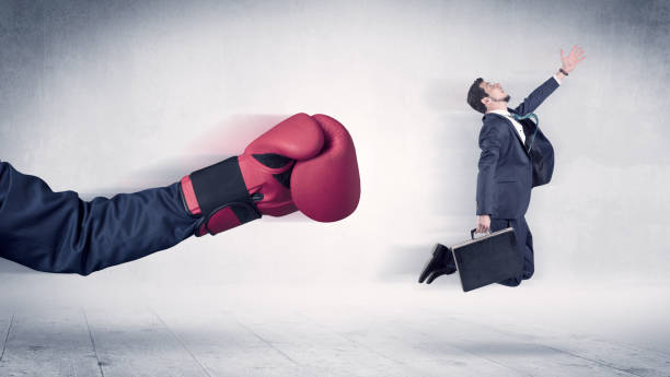 istock Huge Boxing Gloves punches businessman concept 988236134
