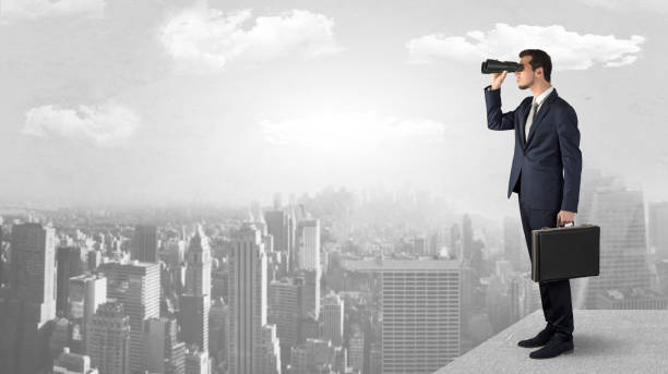 istock Man looking forward from the top of a skyscraper 988239902
