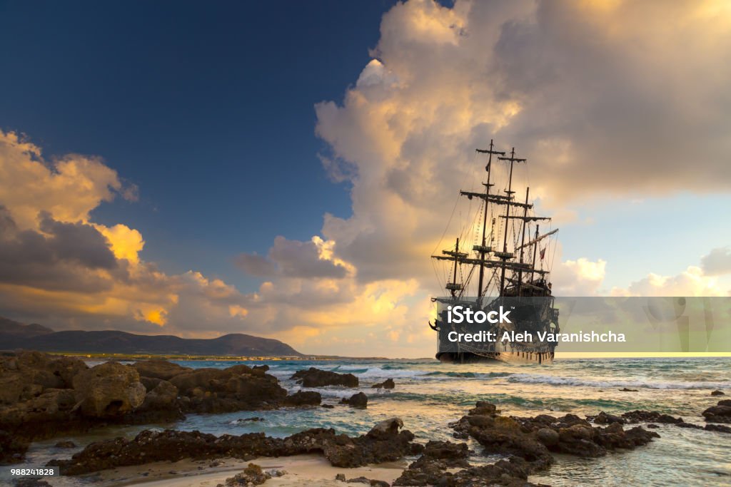 Pirate ship at the open sea Pirate ship at the open sea at the sunset Pirate - Criminal Stock Photo