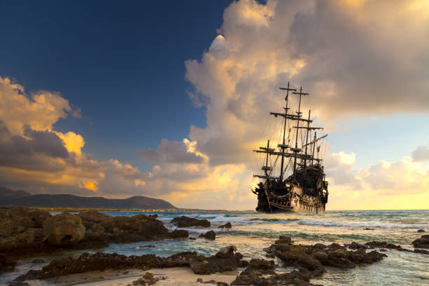 Pirate ship at the open sea Pirate ship at the open sea at the sunset frigate stock pictures, royalty-free photos & images