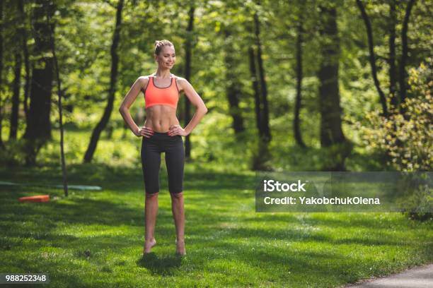 Cheerful Lady Is Tiptoeing On Grass Stock Photo - Download Image Now - Tiptoe, Warm Up Exercise, Sports Training