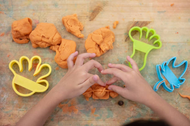 istock Children's hands Playing Colorful Clay 988252706