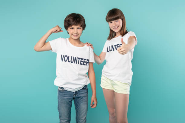 istock Cheerful volunteers showing their muscles 988255048