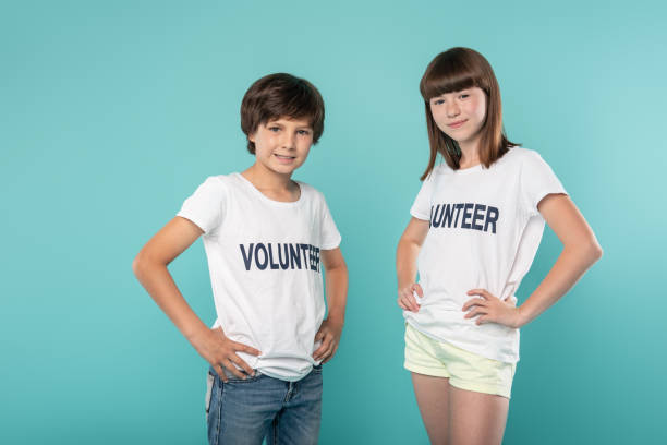 istock Content volunteers holding their hands on their waists 988257242