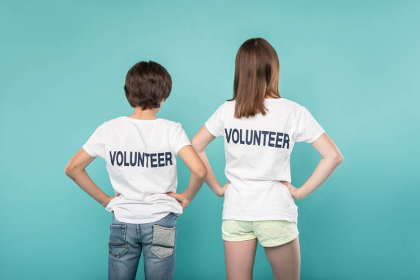 istock Young volunteers holding their hands on their waists 988257540