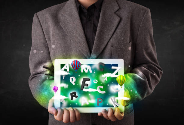 istock Young person showing tablet with abstract letters and sky 988286612