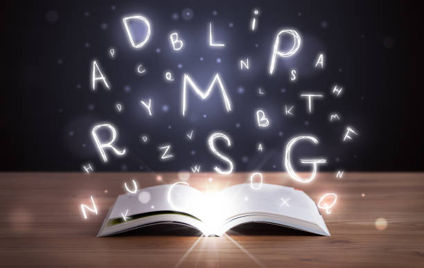 istock Open book with glowing letters flying out 988287144