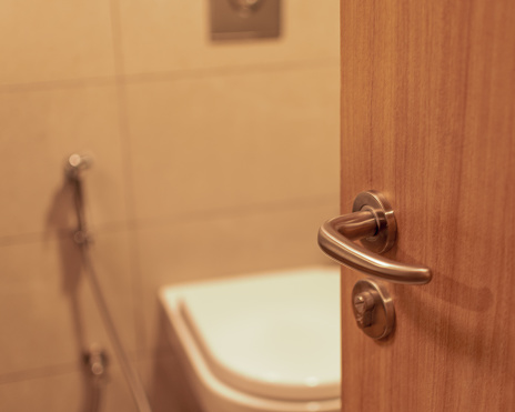 Blurred Bathroom comod with door handle applying selective focus