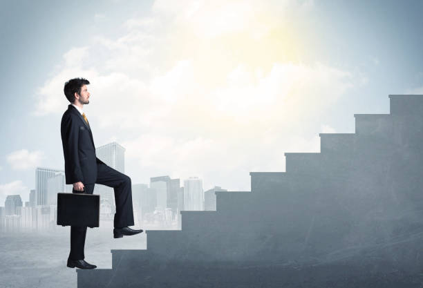 istock Businessman climbing up a concrete staircase concept 988292576