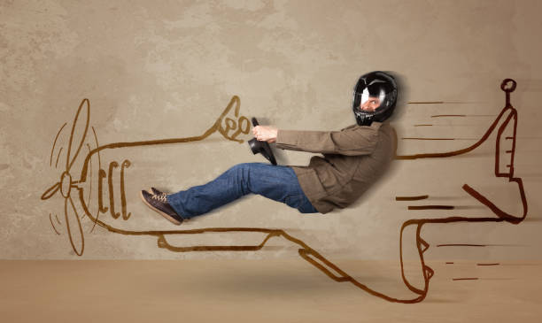 istock Funny pilot driving a hand drawn airplane on the wall 988302000