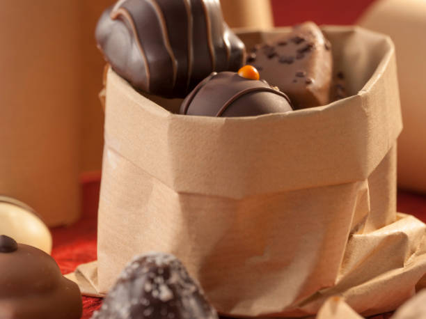 Paper bag with decorative chocolates stock photo