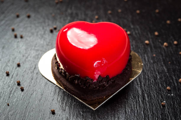 istock Heart shaped red velvet cake with chocolate 988316842