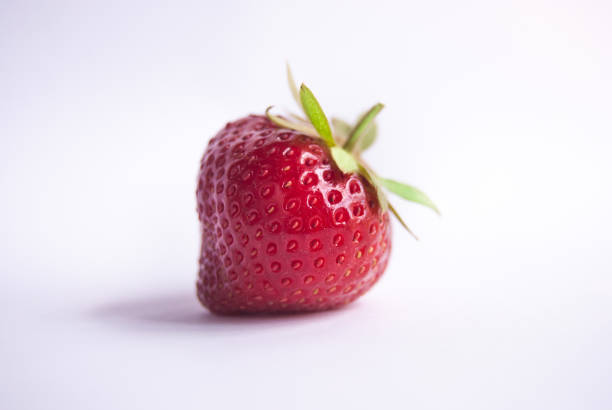 istock Single strawberry with petiole and leaves 988320586