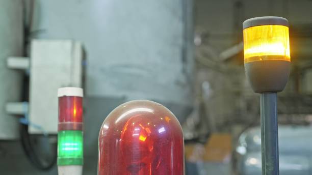 istock Warning light on processing machine. Closeup flashing red lamp on machine in toilet paper production plant large workshop. Red siren on metal cabinet. Warning light for safety on work area. 988330280