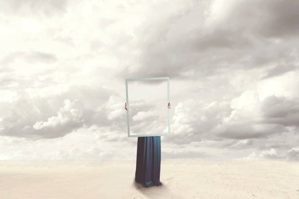 surreal moment of a woman hiding behind a picture of clouds equal to the landscape stock photo