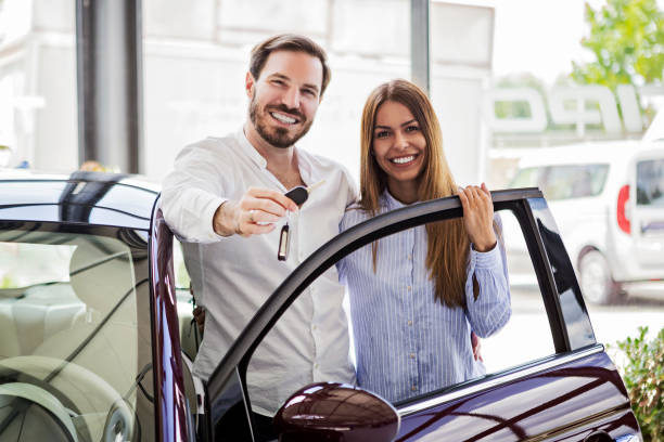 istock Young couple buying first car 988336212