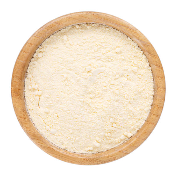 istock Fine cornmeal or corn flour in wooden bowl isolated on white. Top view. 988341114
