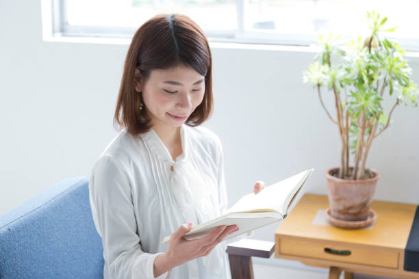 istock A woman reading a book in the room 988342492