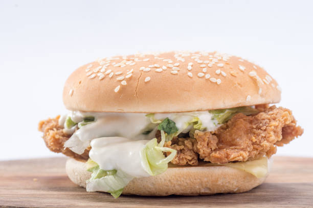 istock Crispy chicken burger with lettuce, cheese, and mayonnaise 988353260
