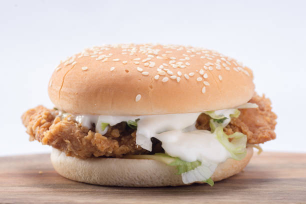 istock Crispy chicken burger with lettuce, cheese, and mayonnaise 988353264