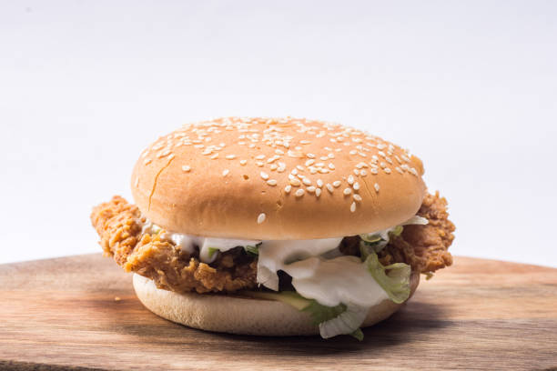 istock Crispy chicken burger with lettuce, cheese, and mayonnaise 988353290