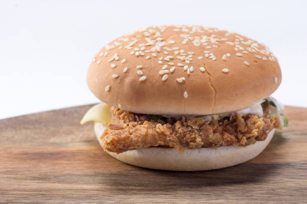 istock Crispy chicken burger with lettuce, cheese, and mayonnaise 988353428