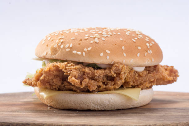 istock Crispy chicken burger with lettuce, cheese, and mayonnaise 988353468