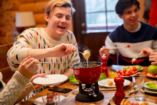 istock Young Man Eating Fondue 988353544