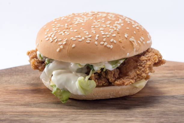 istock Crispy chicken burger with lettuce, cheese, and mayonnaise 988353588