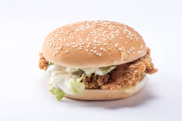 istock Crispy chicken burger with lettuce, cheese, and mayonnaise 988353608