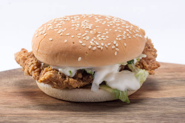 istock Crispy chicken burger with lettuce, cheese, and mayonnaise 988353634