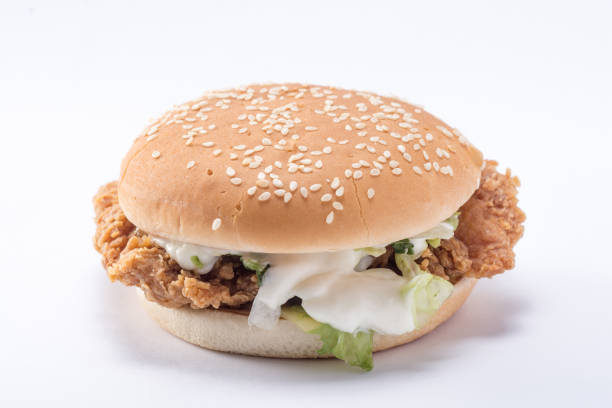 istock Crispy chicken burger with lettuce, cheese, and mayonnaise 988353676