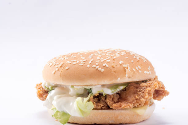 istock Crispy chicken burger with lettuce, cheese, and mayonnaise 988353846