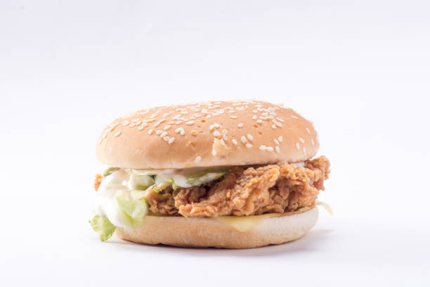 istock Crispy chicken burger with lettuce, cheese, and mayonnaise 988354038
